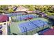Aerial view of tennis courts showing the surrounding neighborhood and trees at 4932 S Verbena Ave, Gilbert, AZ 85298