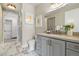 Elegant bathroom with marble floors, gray vanity, and walk-in shower with glass door at 5250 E Deer Valley Dr # 206, Phoenix, AZ 85054