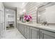 Elegant bathroom with double vanities, granite counters, decorative tile, and walk in closet at 5250 E Deer Valley Dr # 206, Phoenix, AZ 85054