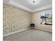 Bright bedroom featuring patterned accent wall and a large window overlooking the patio area at 5250 E Deer Valley Dr # 206, Phoenix, AZ 85054