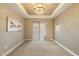Serene bedroom featuring a tray ceiling, plush carpeting, and a sliding door at 5250 E Deer Valley Dr # 206, Phoenix, AZ 85054