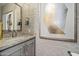 Chic powder room featuring a granite countertop vanity, designer wallpaper, and modern fixtures at 5250 E Deer Valley Dr # 206, Phoenix, AZ 85054