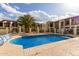A clean community swimming pool with inviting clear water with lounge chairs nearby at 5518 E Lindstrom Ln # 3012, Mesa, AZ 85215