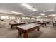 Bright game room featuring multiple billiard tables and natural light from multiple windows at 5518 E Lindstrom Ln # 3012, Mesa, AZ 85215