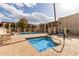 Inviting community hot tub with clear blue water, lounge chairs, and nearby swimming pool at 5518 E Lindstrom Ln # 3012, Mesa, AZ 85215