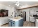 Open kitchen with generous countertop space, a central island, and stainless steel refrigerator at 5518 E Lindstrom Ln # 3012, Mesa, AZ 85215