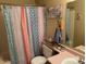 Colorful shower curtain and pink countertop in charming bathroom at 637 E Kramer St, Mesa, AZ 85203