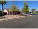 A lovely home with desert landscaping, mature trees, and a well-manicured lawn at 637 E Kramer St, Mesa, AZ 85203
