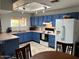 Bright kitchen with blue cabinetry, pink countertops, and tile flooring at 637 E Kramer St, Mesa, AZ 85203