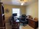 Well-lit home office with a comfortable desk setup, rolling chair, and ample storage at 637 E Kramer St, Mesa, AZ 85203