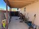 View of covered patio showing yard tools and access to yard at 637 E Kramer St, Mesa, AZ 85203