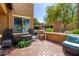 Backyard patio with brick pavers, seating area, mature landscaping, and privacy wall perfect for outdoor entertaining at 7359 W Kings Ave, Peoria, AZ 85382
