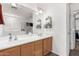 Bathroom featuring double sinks, ample counter space, and a walk-in shower, offering both style and functionality at 7359 W Kings Ave, Peoria, AZ 85382