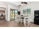 Bright dining area features a ceiling fan, and sliding glass doors leading to the backyard patio at 7359 W Kings Ave, Peoria, AZ 85382