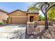 Charming two-story home featuring a two-car garage, inviting front porch, and low maintenance desert landscaping at 7359 W Kings Ave, Peoria, AZ 85382