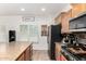 Well-lit kitchen featuring stainless steel appliances, tile backsplash, granite countertops and a cozy island at 7359 W Kings Ave, Peoria, AZ 85382