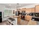Well-lit kitchen featuring stainless steel appliances, tile backsplash, granite countertops and a cozy island at 7359 W Kings Ave, Peoria, AZ 85382