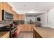 Bright kitchen featuring stainless steel appliances, tile backsplash, granite countertops and breakfast bar at 7359 W Kings Ave, Peoria, AZ 85382