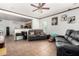 Open-concept living room features tile flooring, ceiling fan, neutral paint, and modern decor at 7359 W Kings Ave, Peoria, AZ 85382
