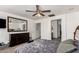 Spacious main bedroom with a ceiling fan, dresser, and a glimpse into the bathroom at 7359 W Kings Ave, Peoria, AZ 85382