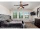 Spacious main bedroom with a unique round bed, ceiling fan, and lots of natural light at 7359 W Kings Ave, Peoria, AZ 85382