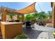 Enjoy this outdoor kitchen and patio featuring a barbecue, shaded dining area, and ample seating at 7359 W Kings Ave, Peoria, AZ 85382