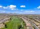 Beautiful aerial showcases homes lining the green golf course, a walkable path, mature trees, and manicured landscaping at 77 E Atole Ct, Queen Creek, AZ 85140