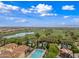 Breathtaking aerial view of the community with golf course, swimming pool, and manicured grounds at 77 E Atole Ct, Queen Creek, AZ 85140