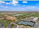 Picturesque aerial view highlighting lush golf course, tennis courts, clubhouse, and community at 77 E Atole Ct, Queen Creek, AZ 85140