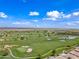Wide aerial shot displays the extensive golf course layout, complete with sand traps, and residential areas at 77 E Atole Ct, Queen Creek, AZ 85140
