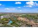 Aerial view highlighting community amenities including a pool, clubhouse, tennis courts, and well-maintained landscaping at 77 E Atole Ct, Queen Creek, AZ 85140