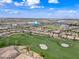 Picturesque aerial shot of community, featuring lush golf course and well-maintained homes at 77 E Atole Ct, Queen Creek, AZ 85140