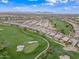 Aerial view highlighting homes nestled beside lush fairways, with pools and scenic golf course views at 77 E Atole Ct, Queen Creek, AZ 85140