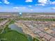 Stunning aerial perspective captures a luxurious golf community with scenic water features and meticulously landscaped properties in Arizona at 77 E Atole Ct, Queen Creek, AZ 85140