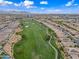 Beautiful aerial showcases homes lining the green golf course, a walkable path, mature trees, and manicured landscaping at 77 E Atole Ct, Queen Creek, AZ 85140