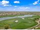 Scenic aerial of the golf course community showcasing beautiful homes and a well-maintained green with a lake at 77 E Atole Ct, Queen Creek, AZ 85140