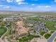 Scenic aerial view showing clubhouse amenities, tennis courts, and golf course, creating a vibrant community at 77 E Atole Ct, Queen Creek, AZ 85140