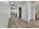 Bright entryway showcasing wood-look tile floors and an open floor plan leading to the living area at 77 E Atole Ct, Queen Creek, AZ 85140