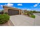 Lovely home with a two-car garage, desert landscaping, and a well-maintained front yard at 77 E Atole Ct, Queen Creek, AZ 85140
