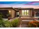 Inviting home featuring desert landscaping and a cozy front porch at 77 E Atole Ct, Queen Creek, AZ 85140