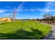 Scenic view of the community golf course with lush green grass and a beautiful blue sky backdrop at 77 E Atole Ct, Queen Creek, AZ 85140