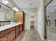Well-lit bathroom with a double vanity, large cabinet, and walk-in shower at 77 E Atole Ct, Queen Creek, AZ 85140