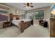 Cozy bedroom with ceiling fan and windows with views of the well maintained landscape at 77 E Atole Ct, Queen Creek, AZ 85140