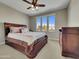 Comfortable main bedroom features plush carpeting, ceiling fan and a large window that provides an abundance of natural light at 77 E Atole Ct, Queen Creek, AZ 85140