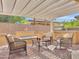 Inviting covered patio with brick pavers features comfortable seating, a built in grill, and a fire pit at 77 E Atole Ct, Queen Creek, AZ 85140