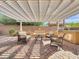 Relaxing outdoor covered patio area with brick pavers, seating, a grill, and a fire pit at 77 E Atole Ct, Queen Creek, AZ 85140