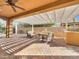 Covered patio features a seating area, a grill, a fire pit, brick pavers and a pergola at 77 E Atole Ct, Queen Creek, AZ 85140