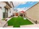 Enclosed backyard with an outdoor kitchen, artificial turf, and ample space for outdoor enjoyment at 8336 E Idaho Ave, Mesa, AZ 85209
