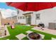 Lush backyard featuring pavers, artificial grass, a grill, and outdoor furniture, perfect for relaxation at 8336 E Idaho Ave, Mesa, AZ 85209