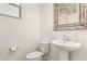 Powder bathroom with decorative mirror and pedestal sink at 8336 E Idaho Ave, Mesa, AZ 85209